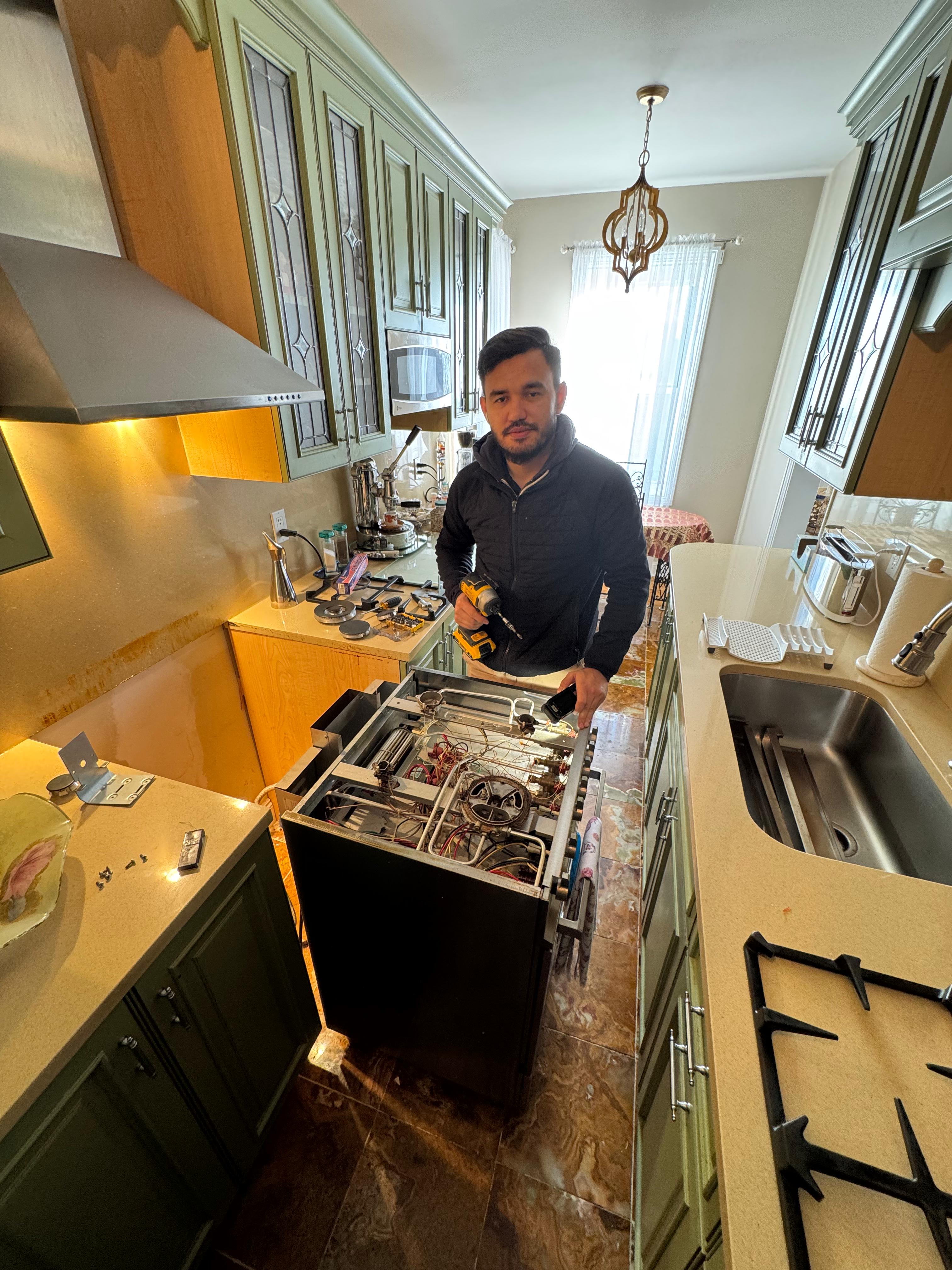 Leonid Rysikov, founder of Up-liance Appliance Repair, working on commercial refrigeration equipment